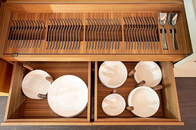 a wooden shelf with dishes on it aboard MIRA 1 Yacht for Sale