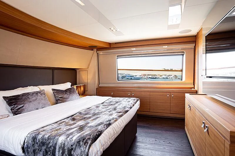 a bedroom with a bed and a dresser aboard MIRA 1 Yacht for Sale