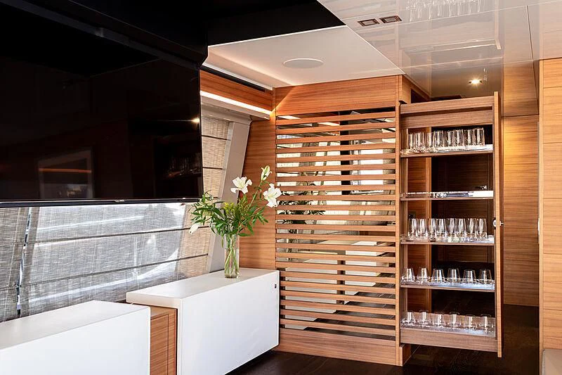 a room with a glass shelf and a vase with flowers in it aboard MIRA 1 Yacht for Sale