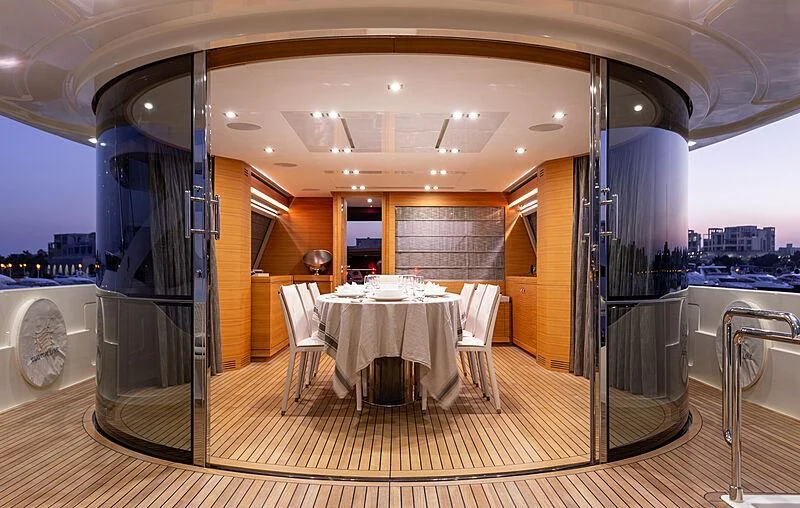 a room with tables and chairs aboard MIRA 1 Yacht for Sale