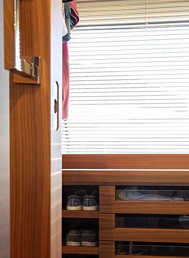 a closet with a door and a shelf with shoes on it aboard MIRA 1 Yacht for Sale