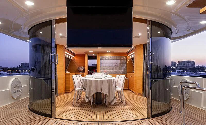 a room with a table and chairs aboard MIRA 1 Yacht for Sale