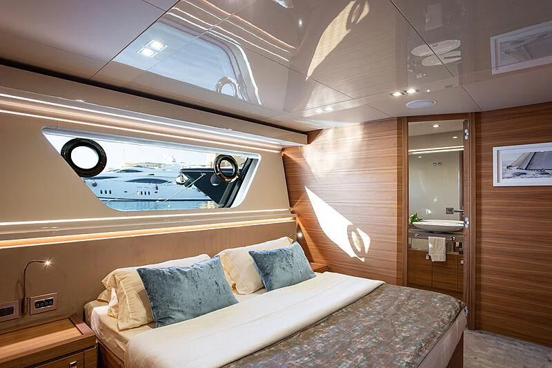 a bedroom with a bed and a mirror aboard MIRA 1 Yacht for Sale
