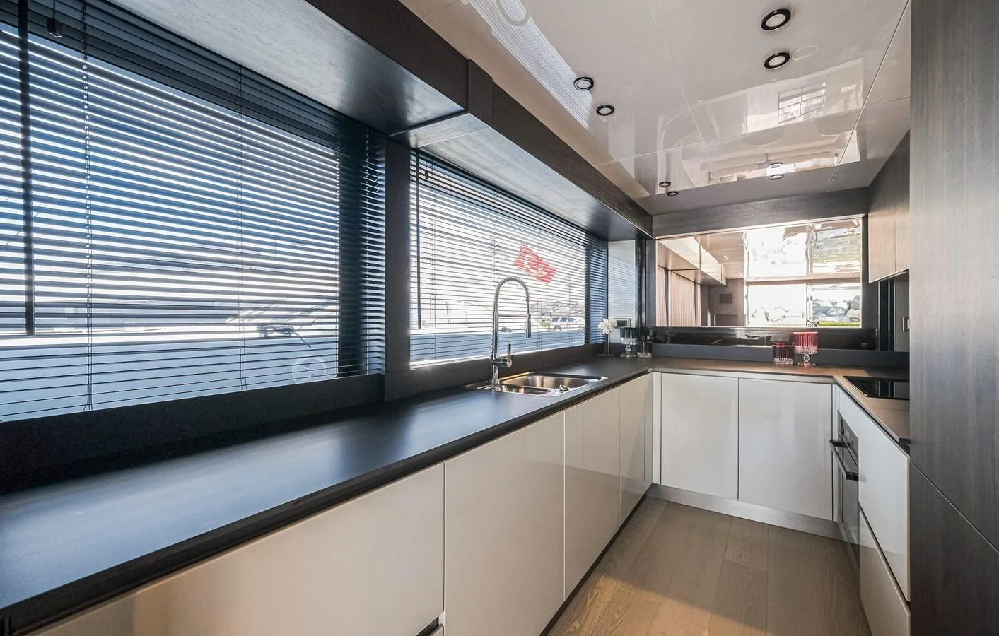 a kitchen with white cabinets aboard ONYX 87/01 Yacht for Sale