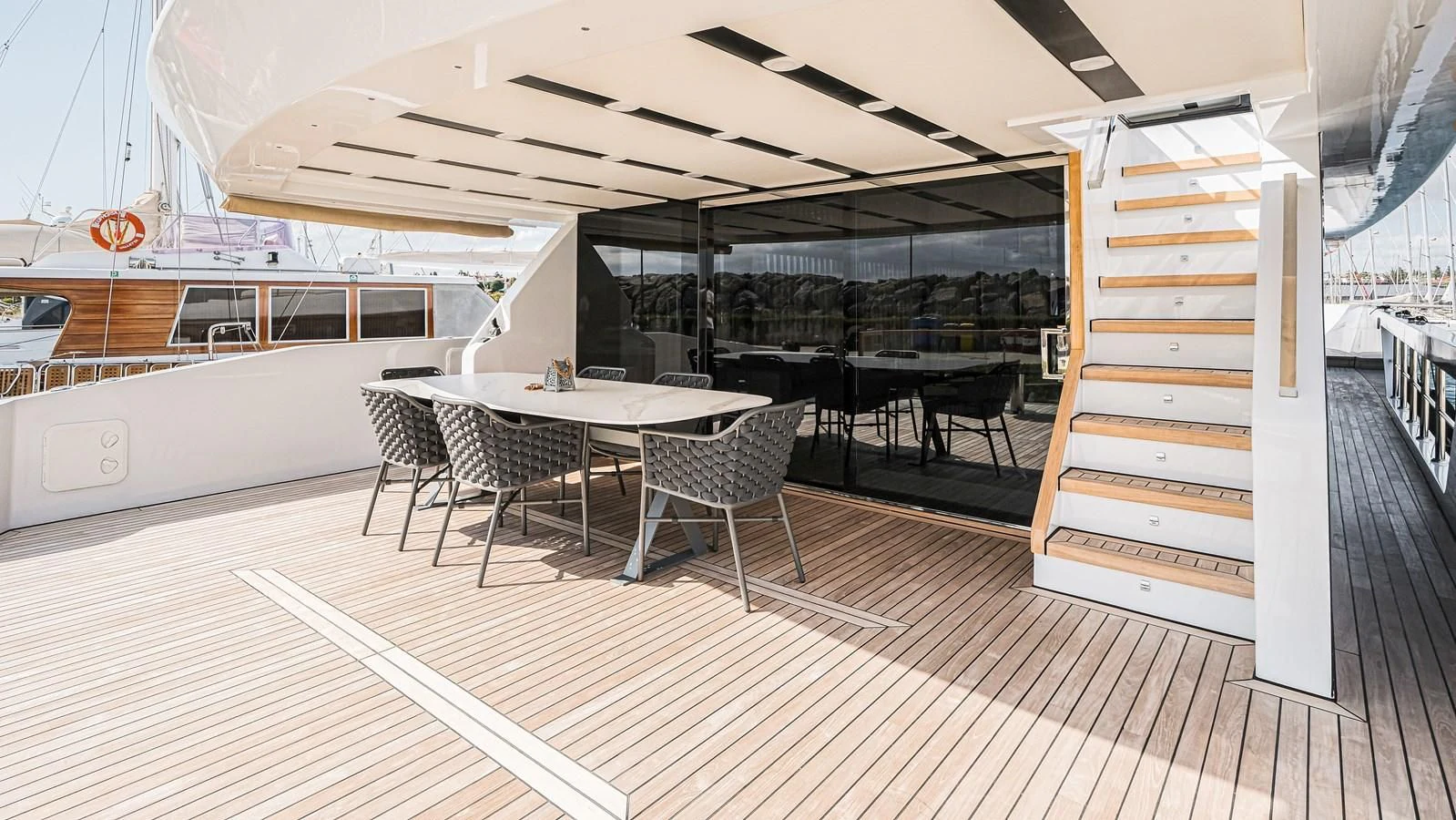 a room with a table chairs and a staircase aboard ONYX 87/01 Yacht for Sale