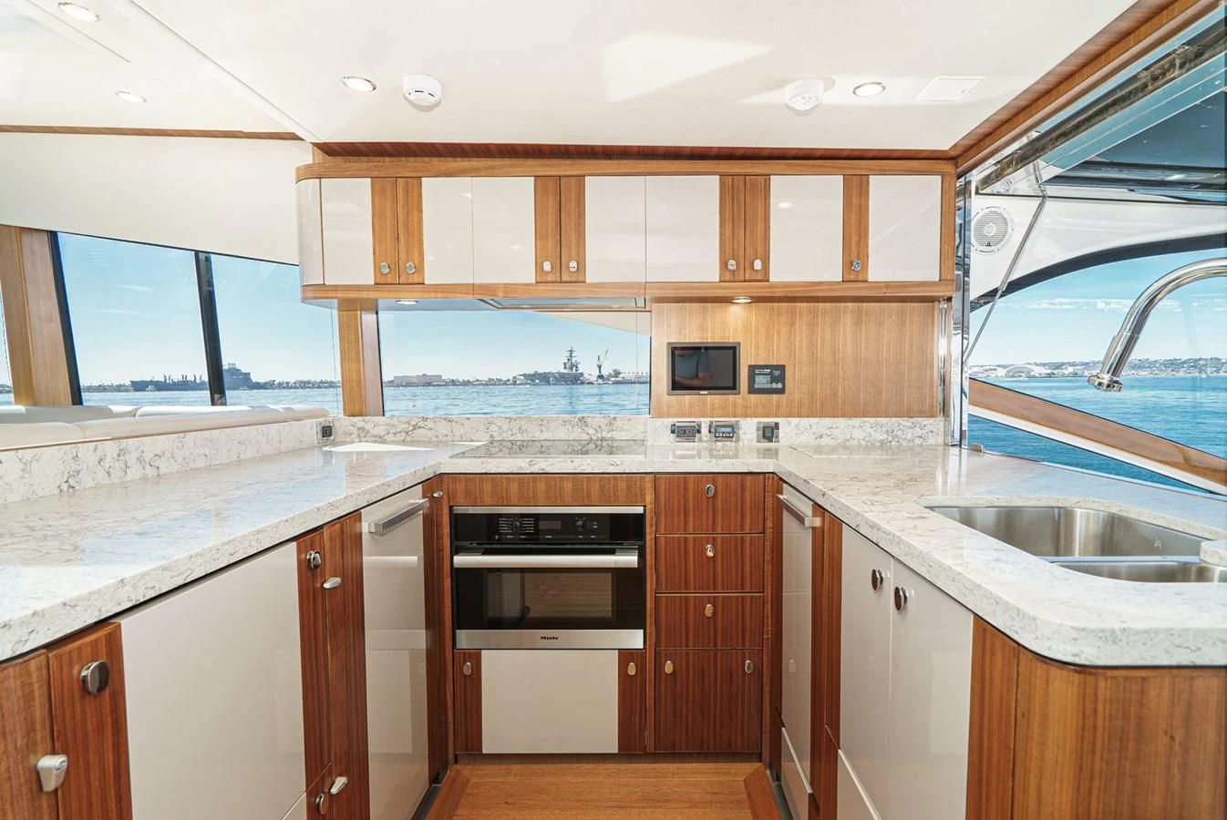 a kitchen with wooden cabinets aboard VALENCIA Yacht for Sale