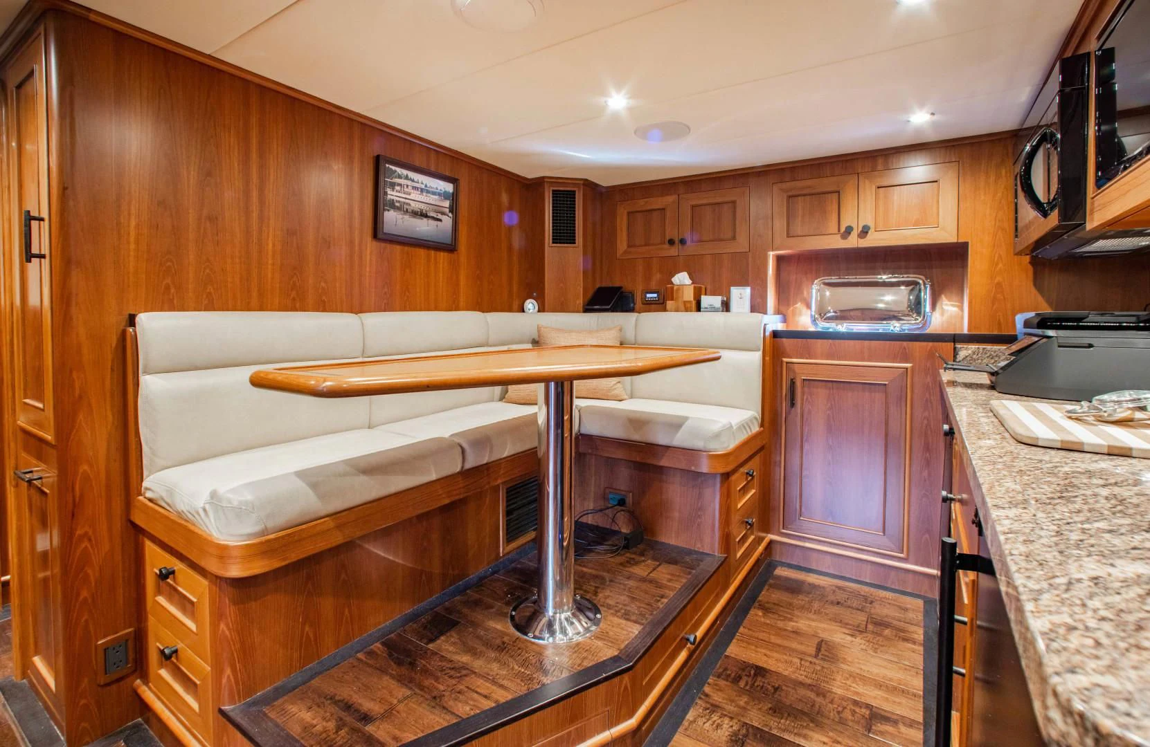 a kitchen with a table and a bench aboard ON LIBERTY Yacht for Sale