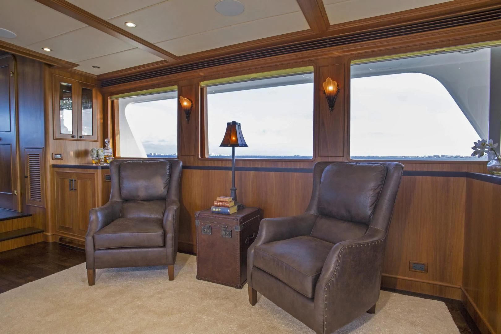 a living room with leather chairs aboard ON LIBERTY Yacht for Sale