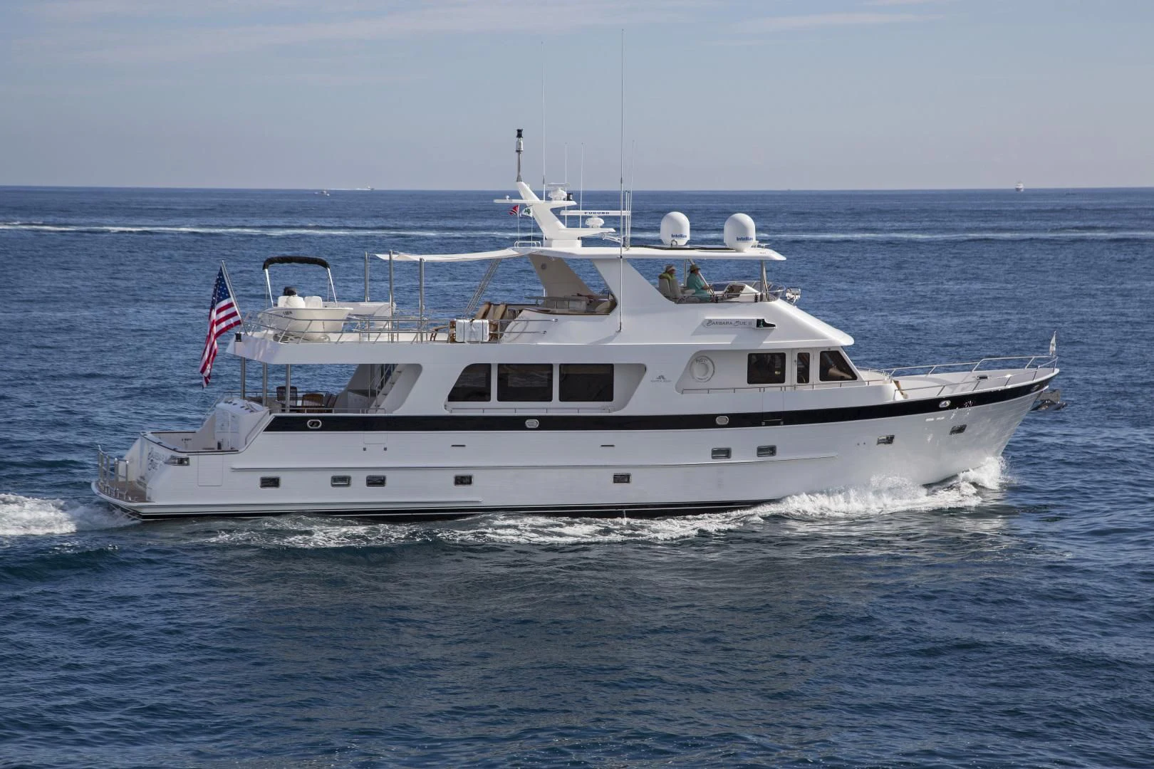 a large white boat with a flag on it aboard ON LIBERTY Yacht for Sale