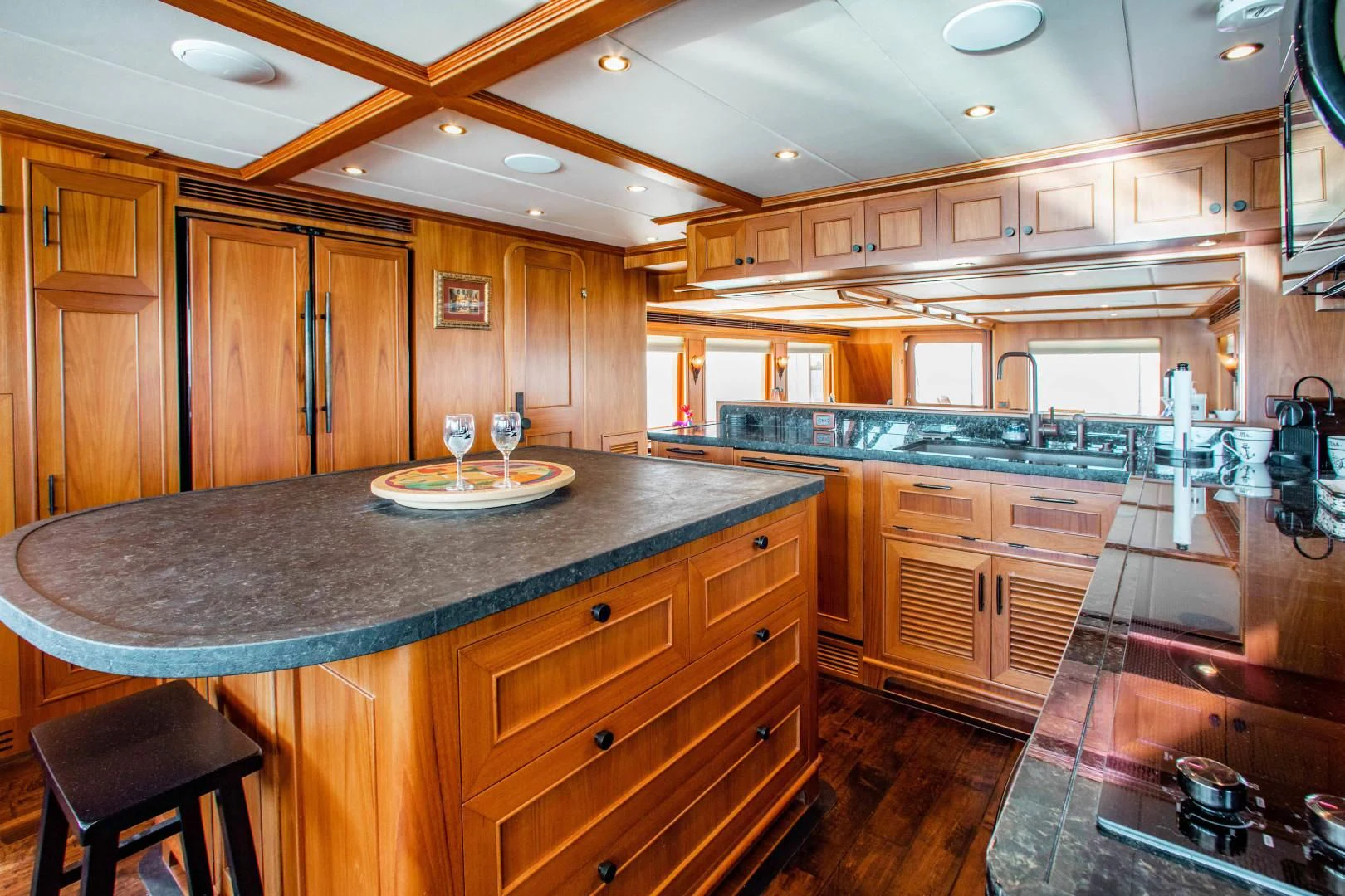 a kitchen with wooden cabinets aboard ON LIBERTY Yacht for Sale