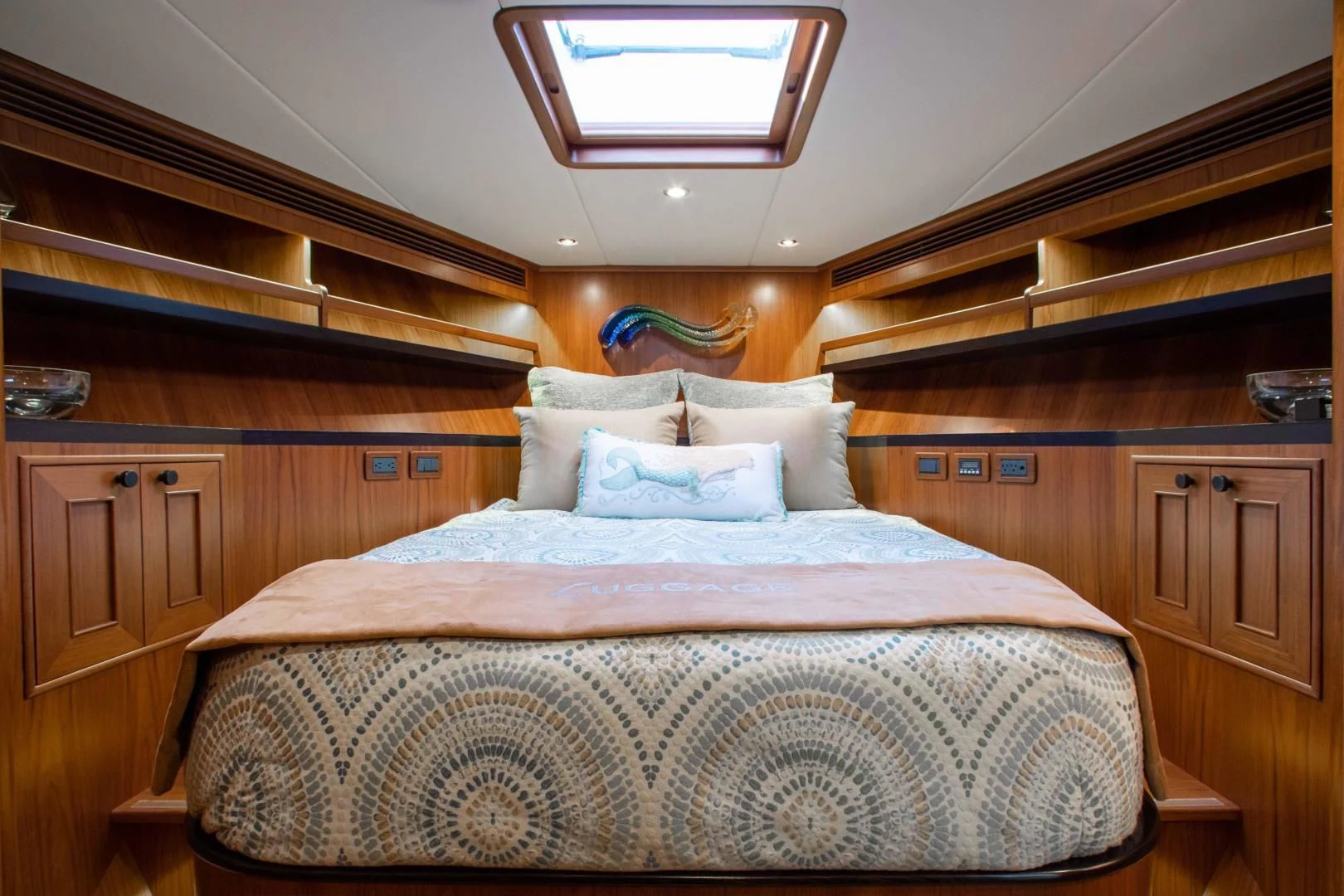 a bed with a wooden headboard aboard ON LIBERTY Yacht for Sale