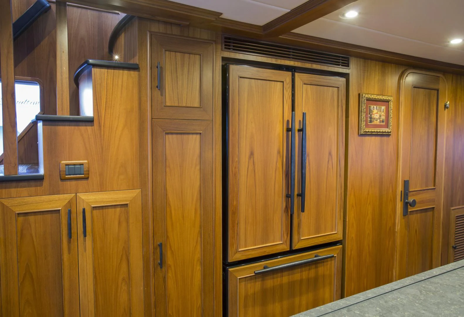 a kitchen with wooden cabinets aboard ON LIBERTY Yacht for Sale
