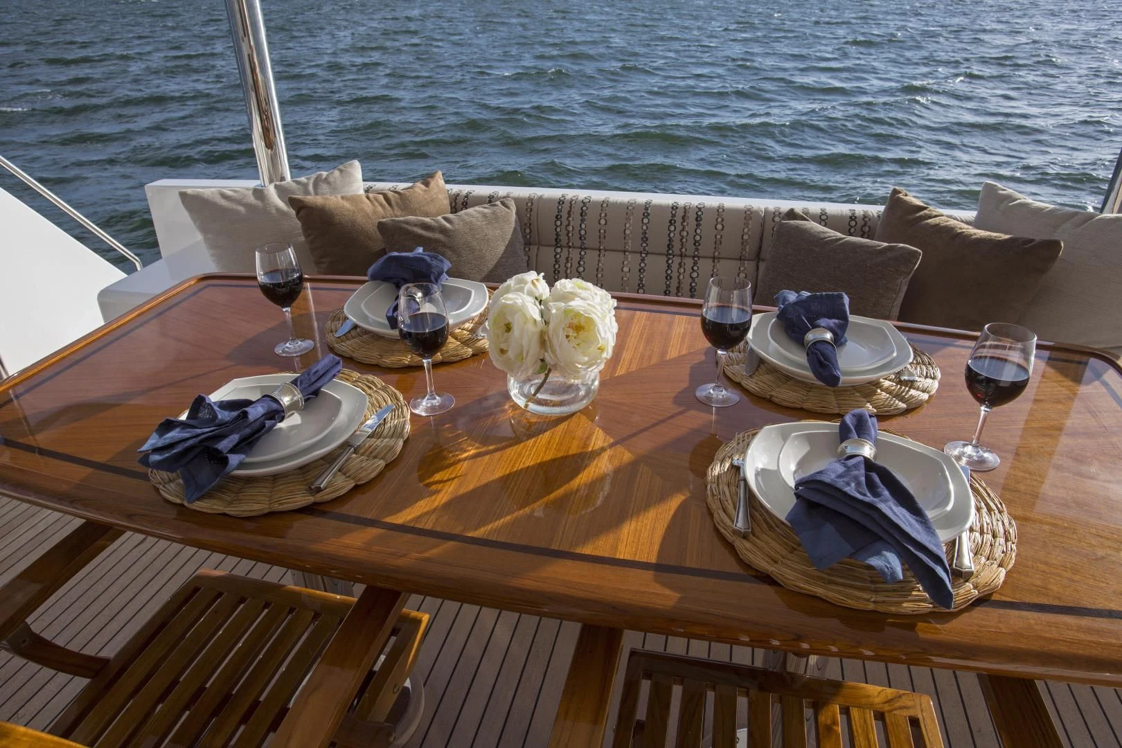 a table with wine glasses and plates on it aboard ON LIBERTY Yacht for Sale