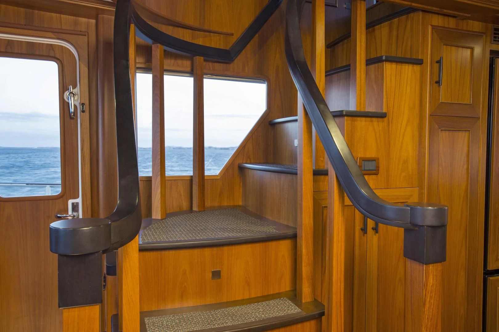 a wooden staircase with a railing aboard ON LIBERTY Yacht for Sale