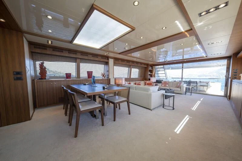 a room with a table and chairs aboard REFLECT Yacht for Sale