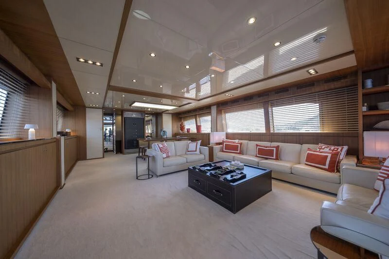 a large room with couches and a table aboard REFLECT Yacht for Sale