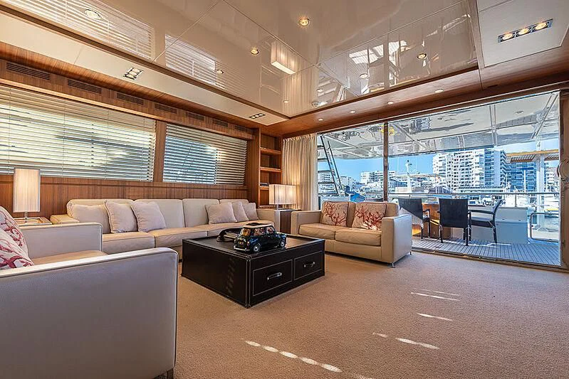 a living room with a couch and a table aboard REFLECT Yacht for Sale