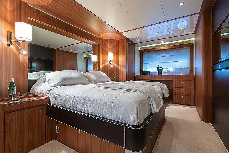 a room with a bed and a window aboard REFLECT Yacht for Sale