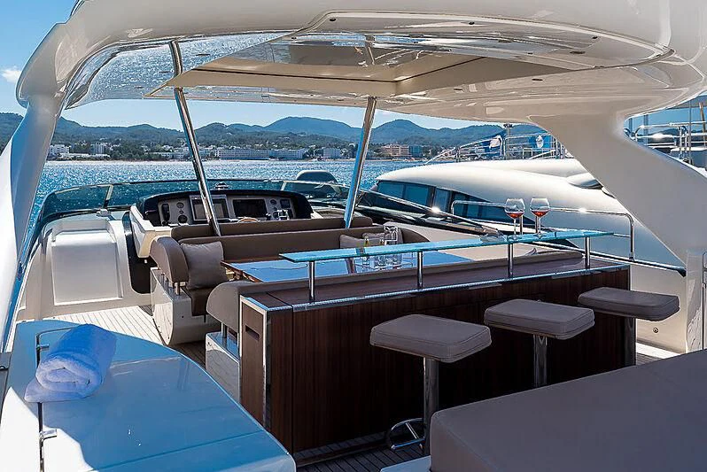 a boat with a view of the ocean and the mountains aboard REFLECT Yacht for Sale
