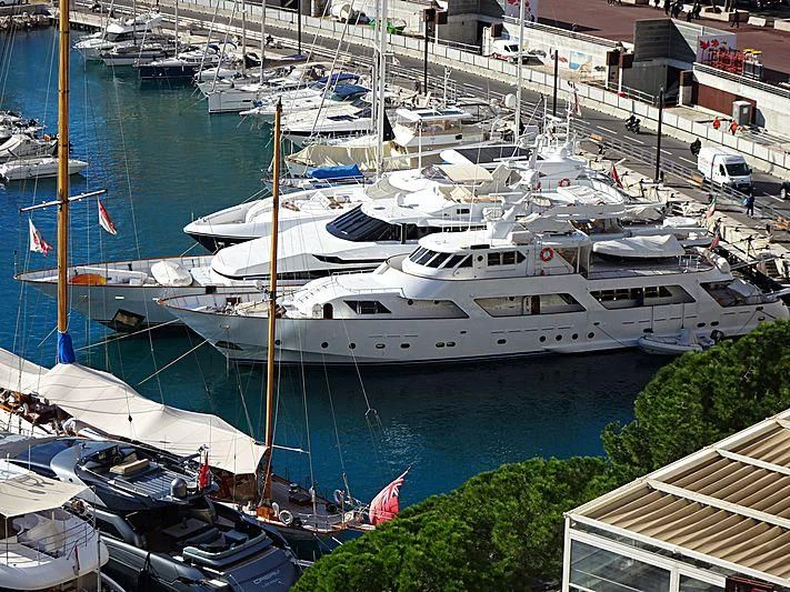 a large white yacht docked at a pier aboard AVA Yacht for Charter
