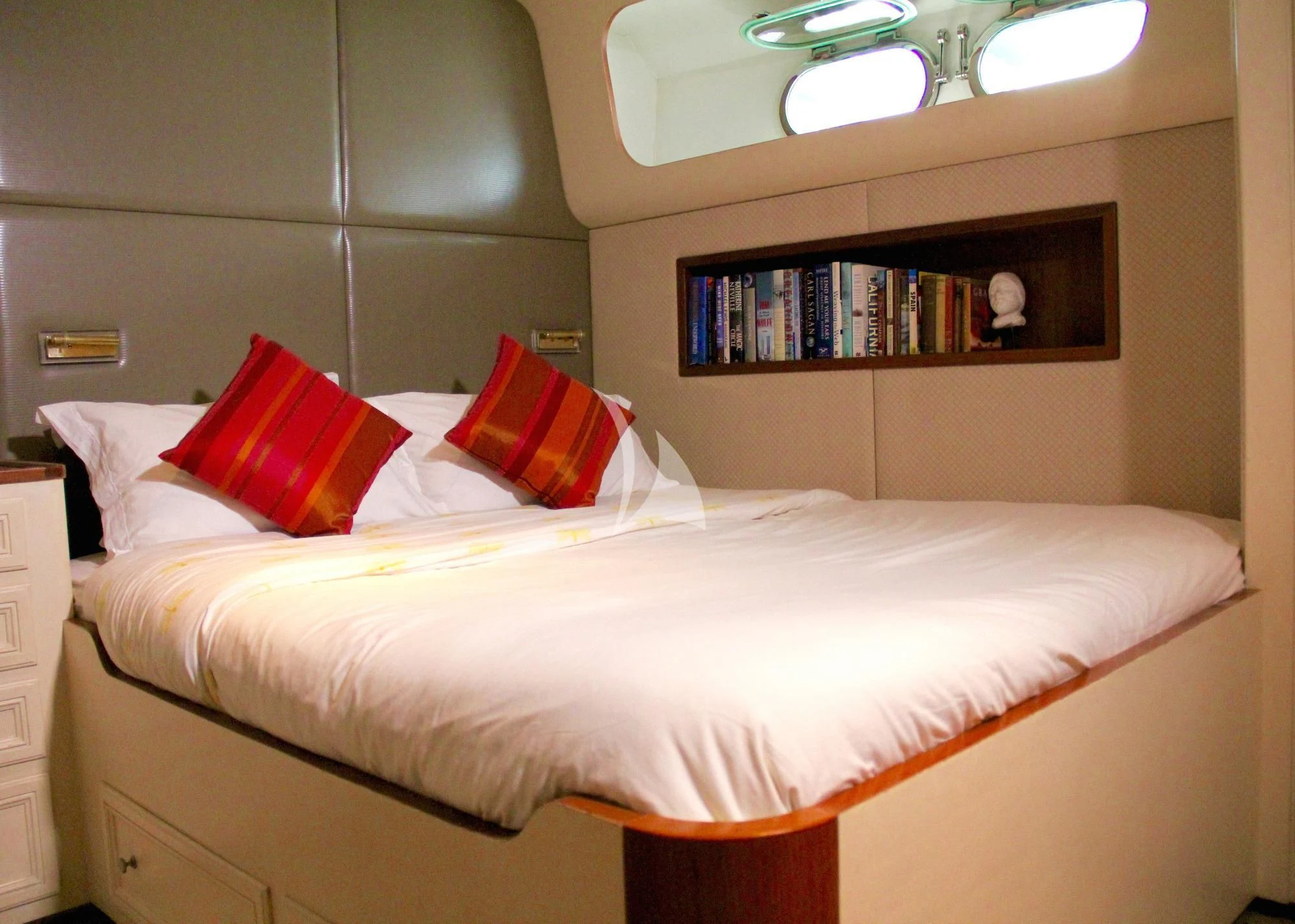 a bed with a white sheet and pillows on it aboard AVA Yacht for Charter