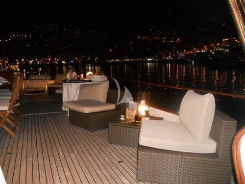 a deck with a view of a city at night aboard AVA Yacht for Charter
