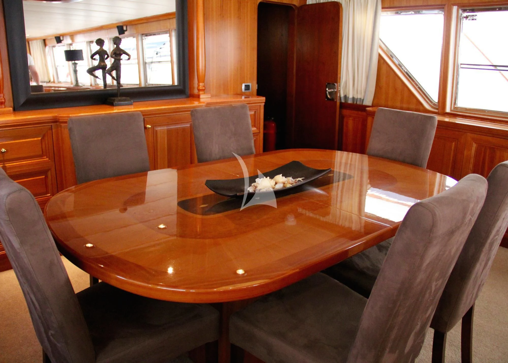 a room with a table and chairs aboard AVA Yacht for Charter