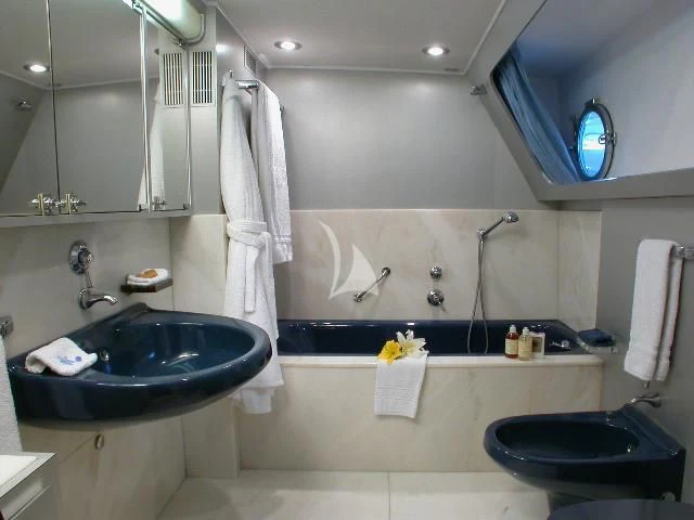 a bathroom with a tub sink and toilet aboard AVA Yacht for Charter