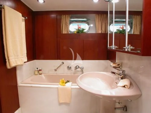 a bathroom with a tub sink and a mirror aboard AVA Yacht for Charter