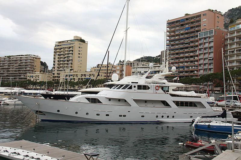 a white yacht in a harbor aboard AVA Yacht for Charter