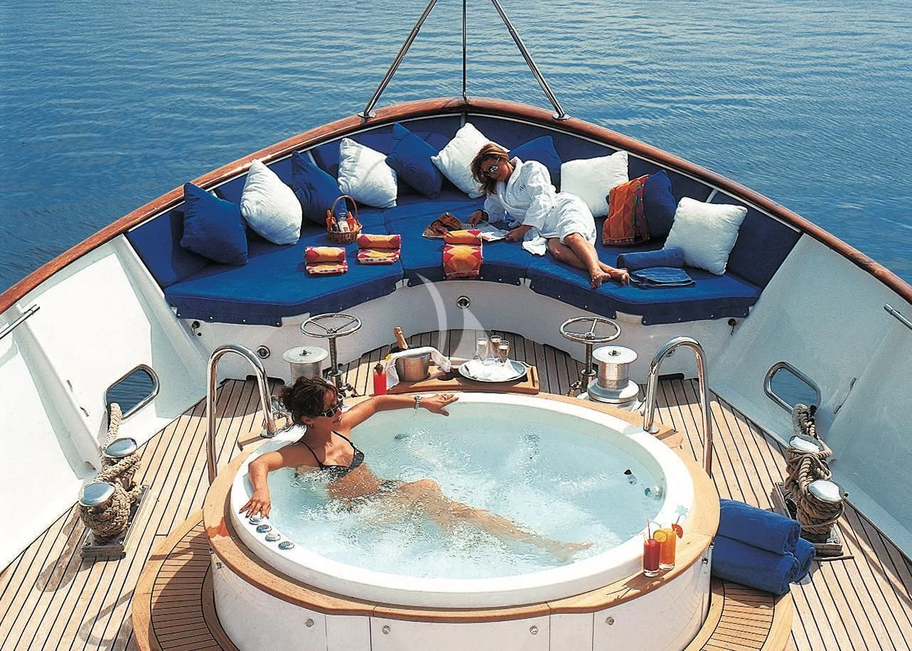 a couple of people in a small boat aboard AVA Yacht for Charter