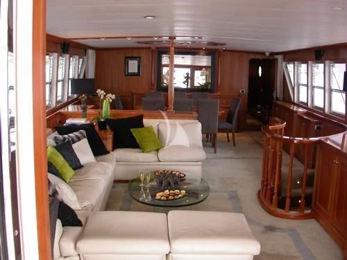 a living room with a couch and a table aboard AVA Yacht for Charter