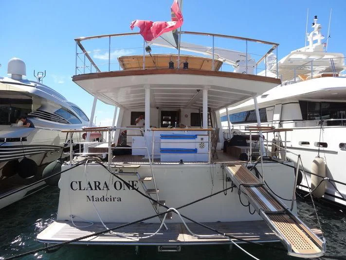 a boat with a flag on the front aboard CLARA ONE Yacht for Sale