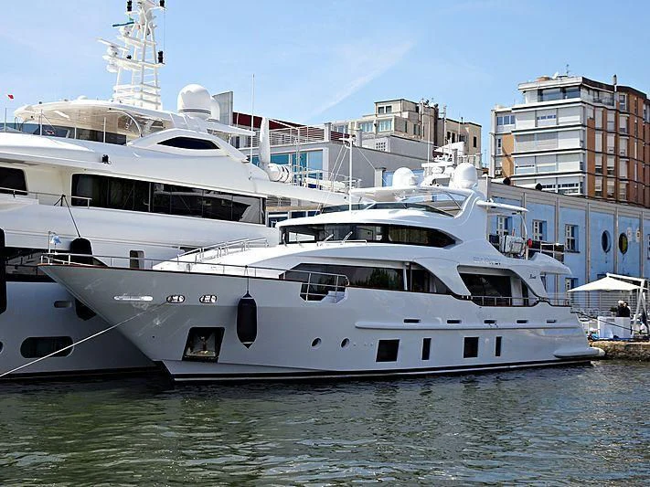 a large white boat in a harbor aboard SEA GYPSY Yacht for Sale