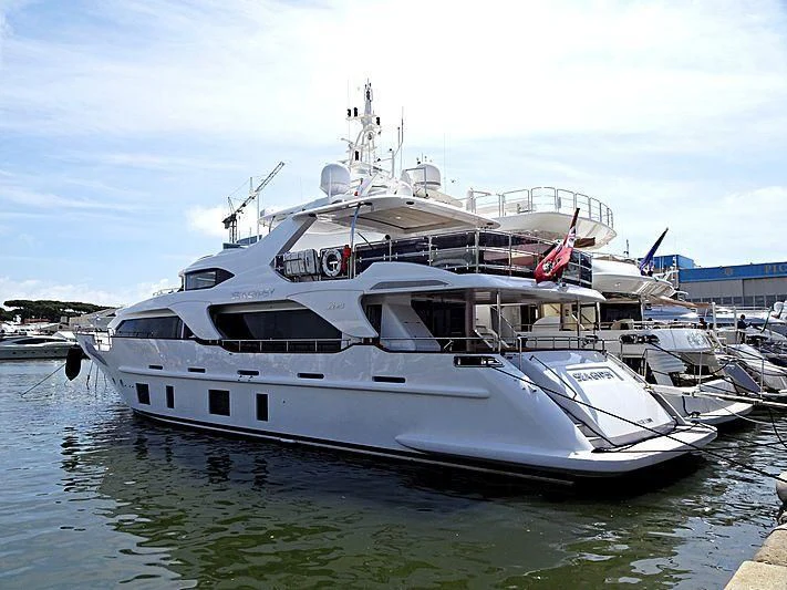 a large white boat in a harbor aboard SEA GYPSY Yacht for Sale