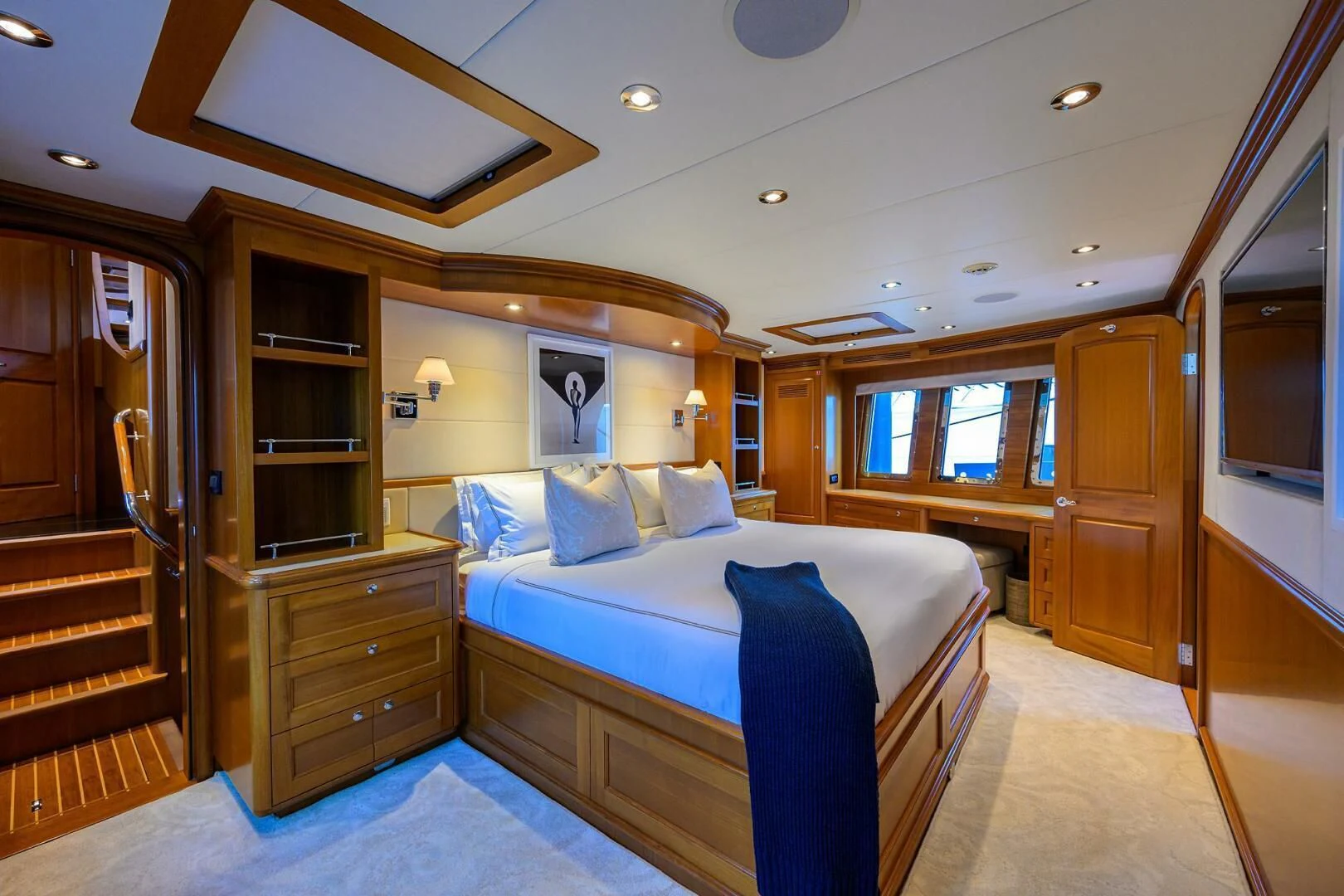a bedroom with a bed and a closet aboard SOLACE Yacht for Sale