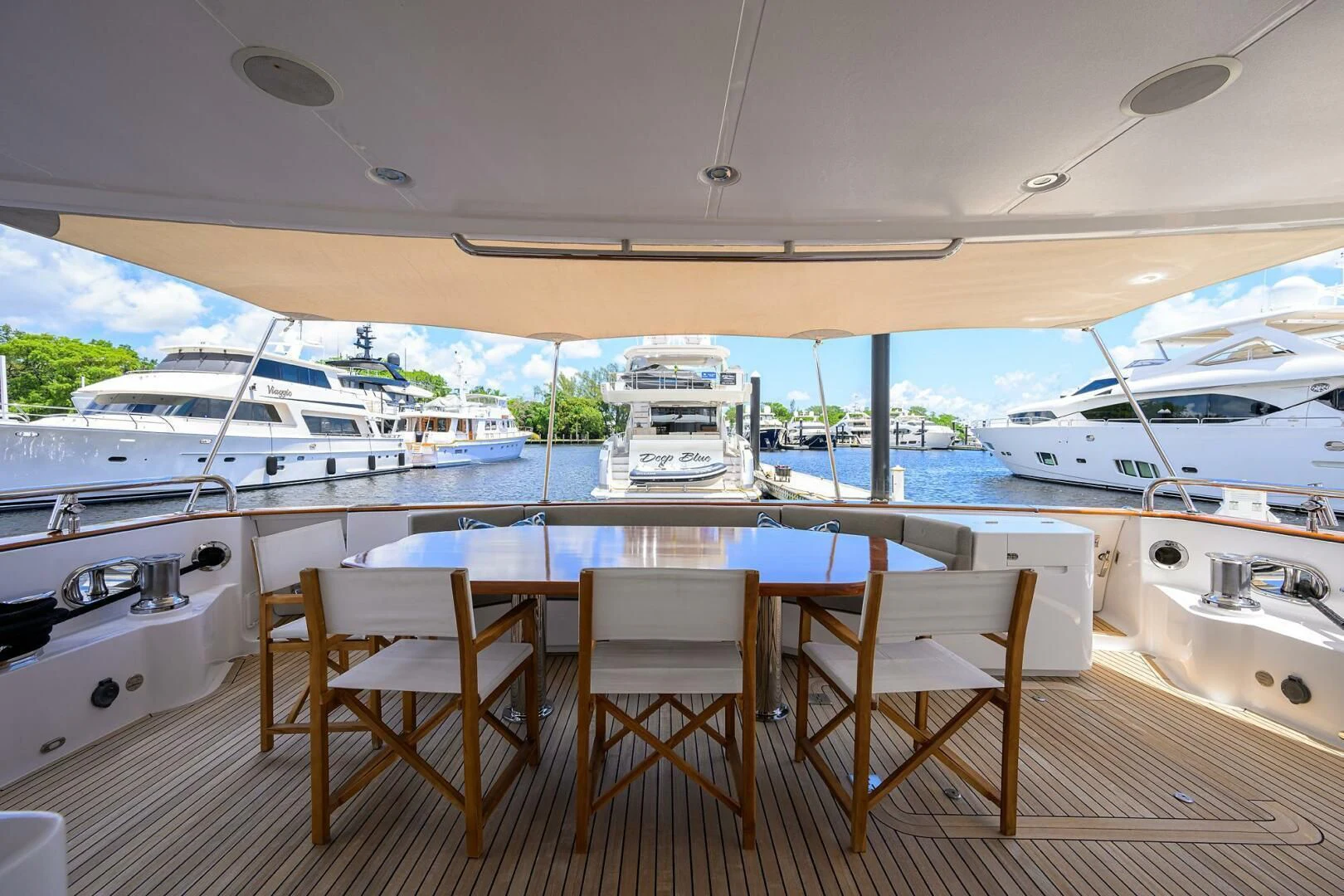 a table and chairs on a deck aboard SOLACE Yacht for Sale