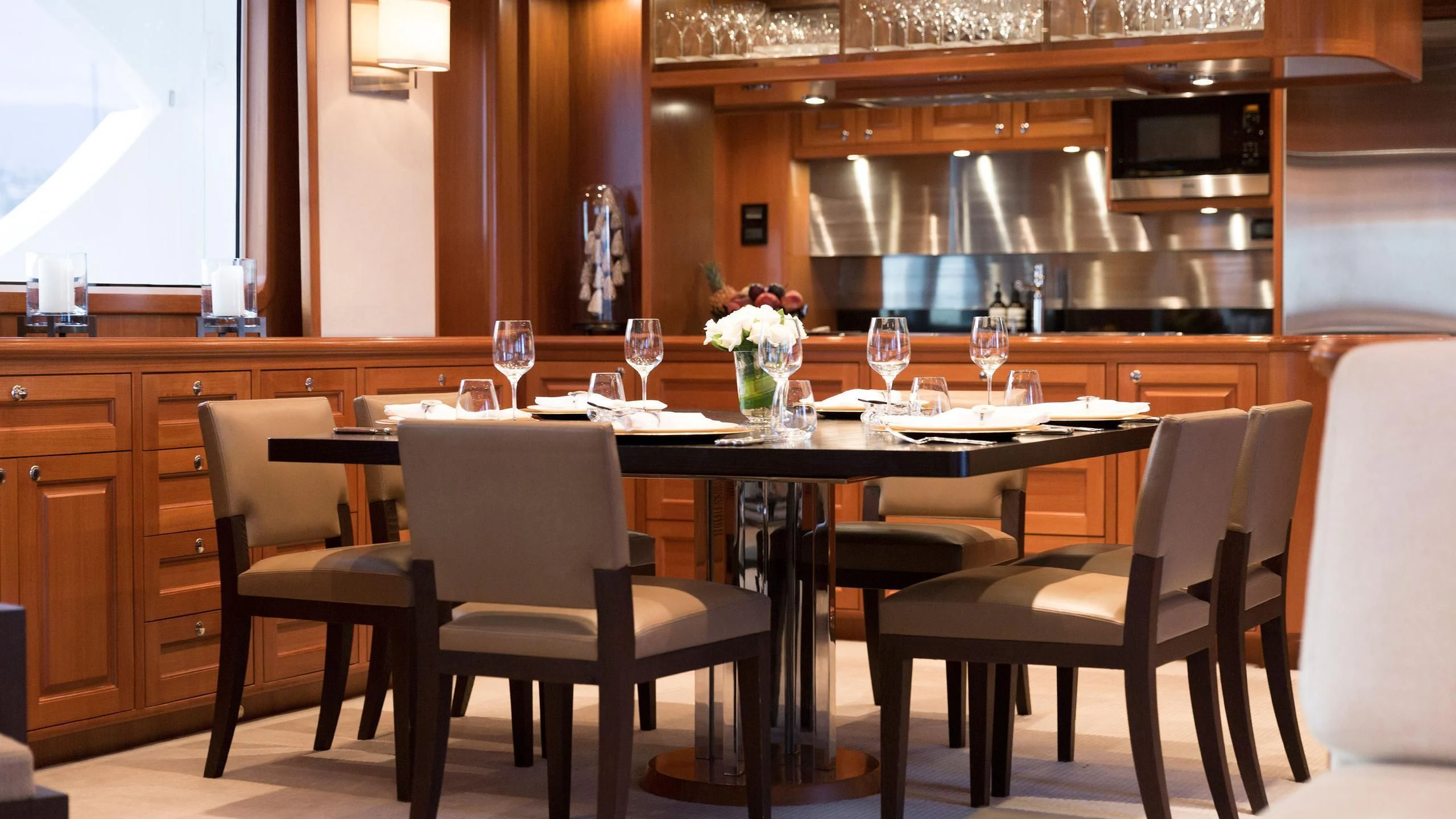 a large kitchen with a table set aboard SOLACE Yacht for Sale