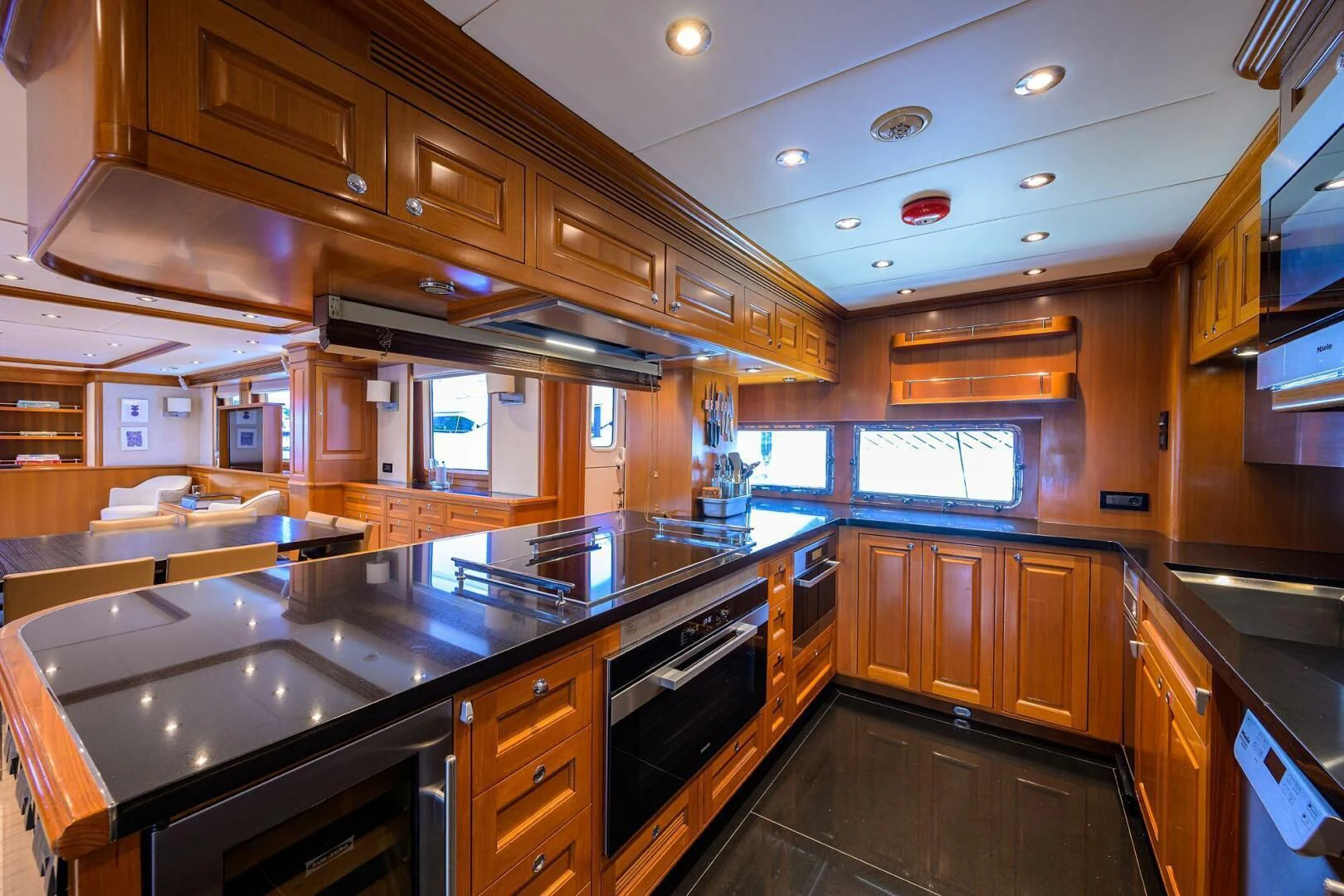 a kitchen with wooden cabinets aboard SOLACE Yacht for Sale