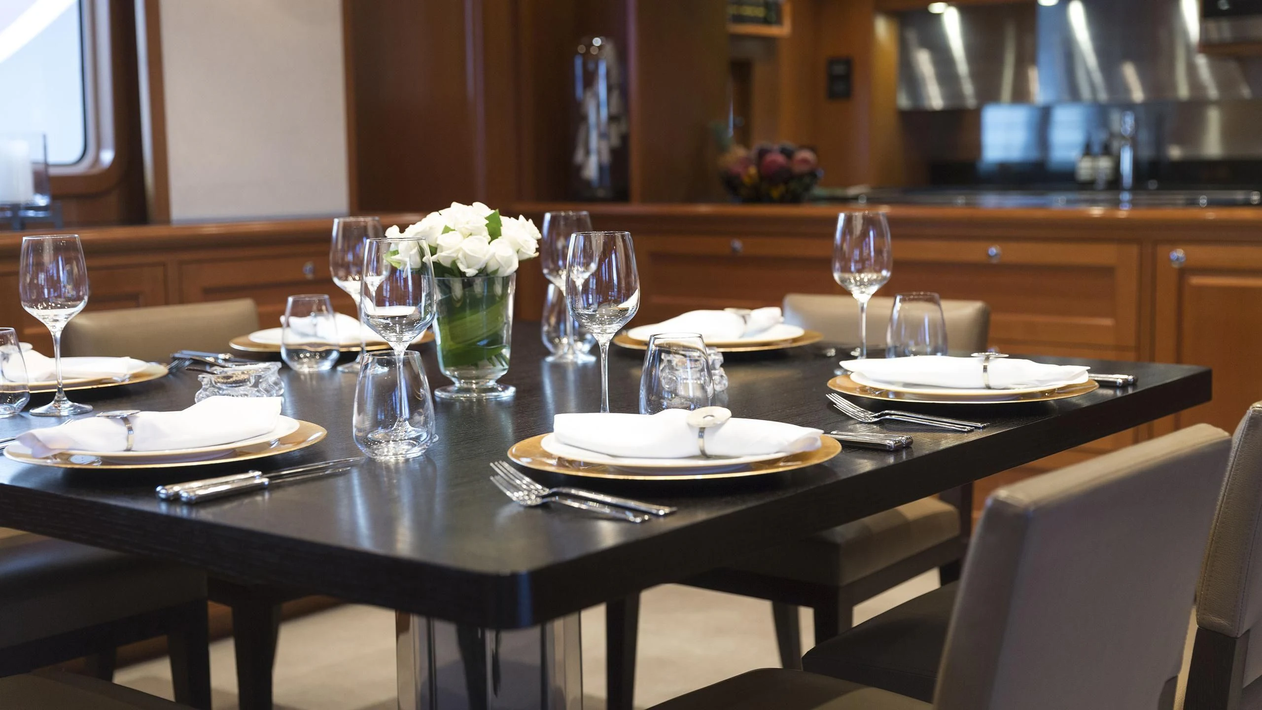 a table set with plates and glasses aboard SOLACE Yacht for Sale