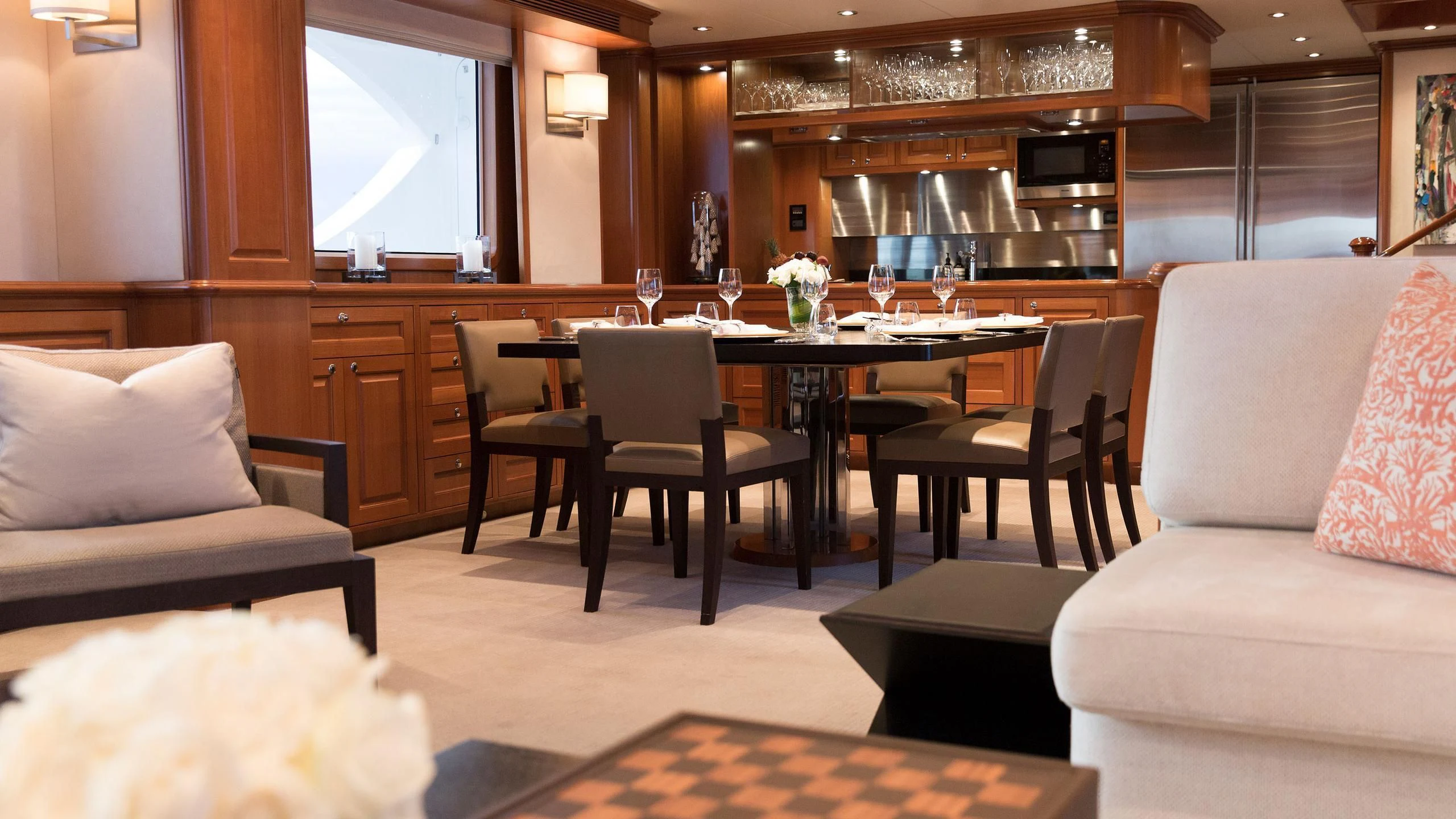 a room with a table chairs and a couch aboard SOLACE Yacht for Sale