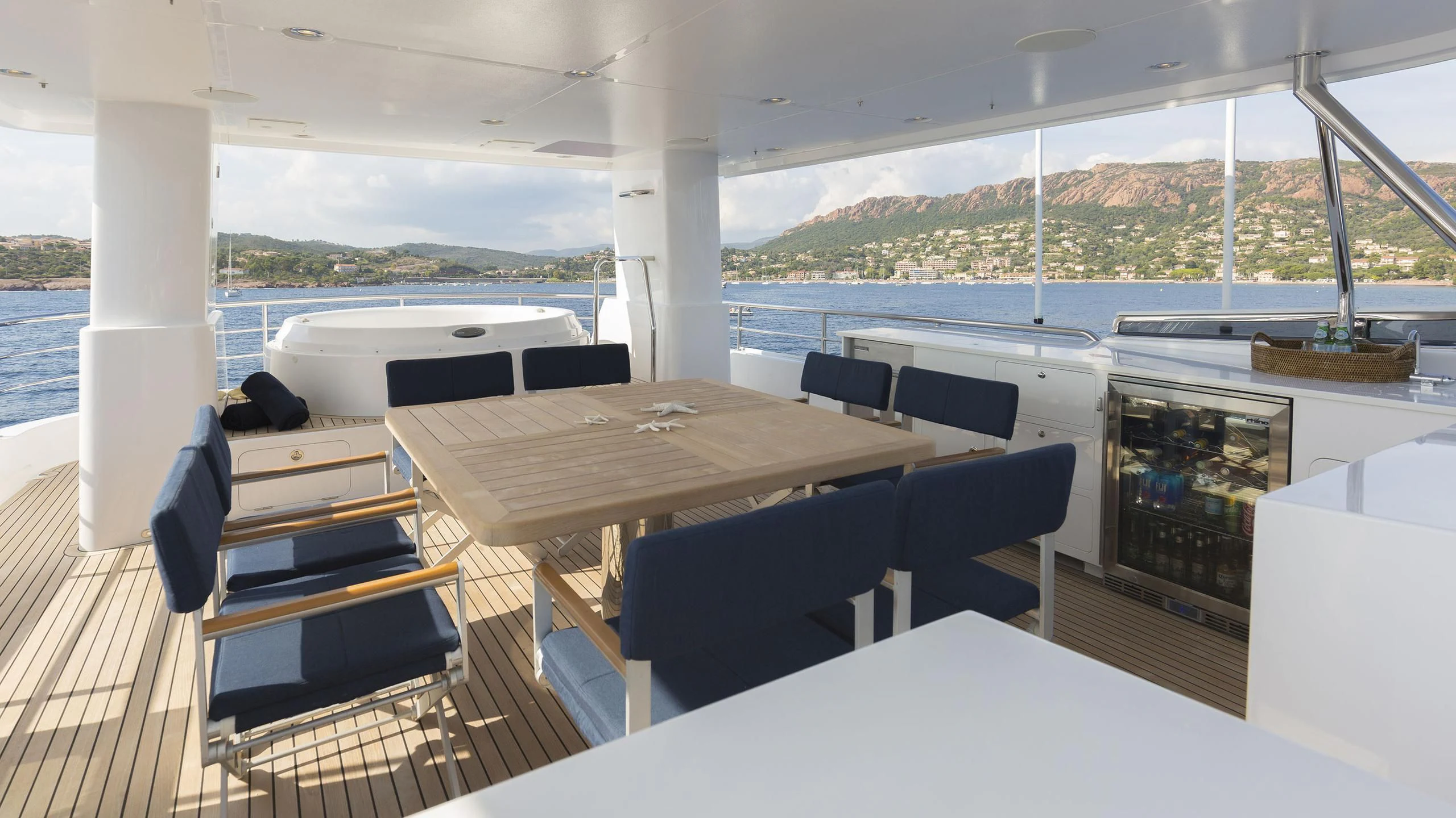 a table with chairs on it aboard SOLACE Yacht for Sale