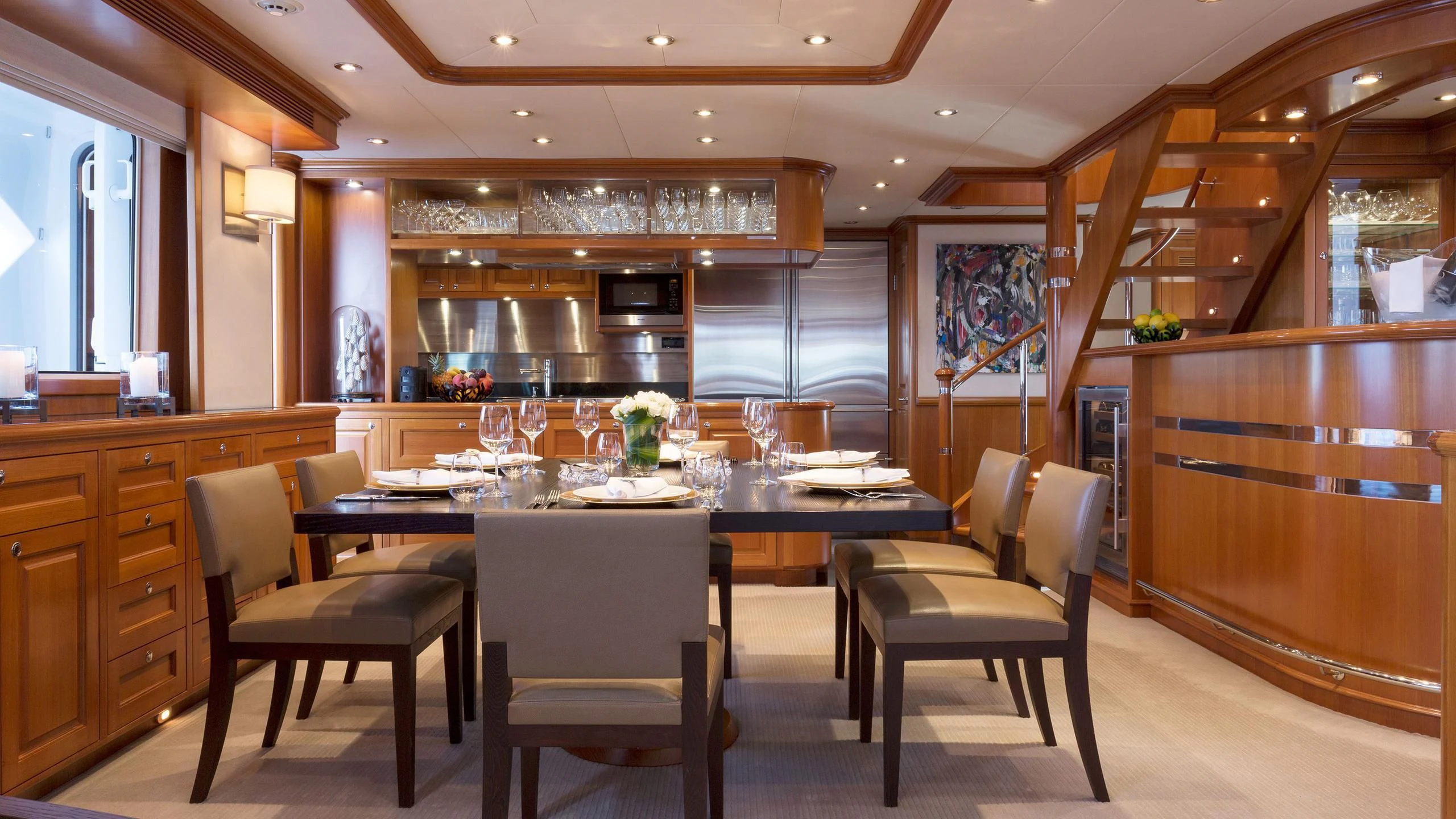 a kitchen with a table and chairs aboard SOLACE Yacht for Sale