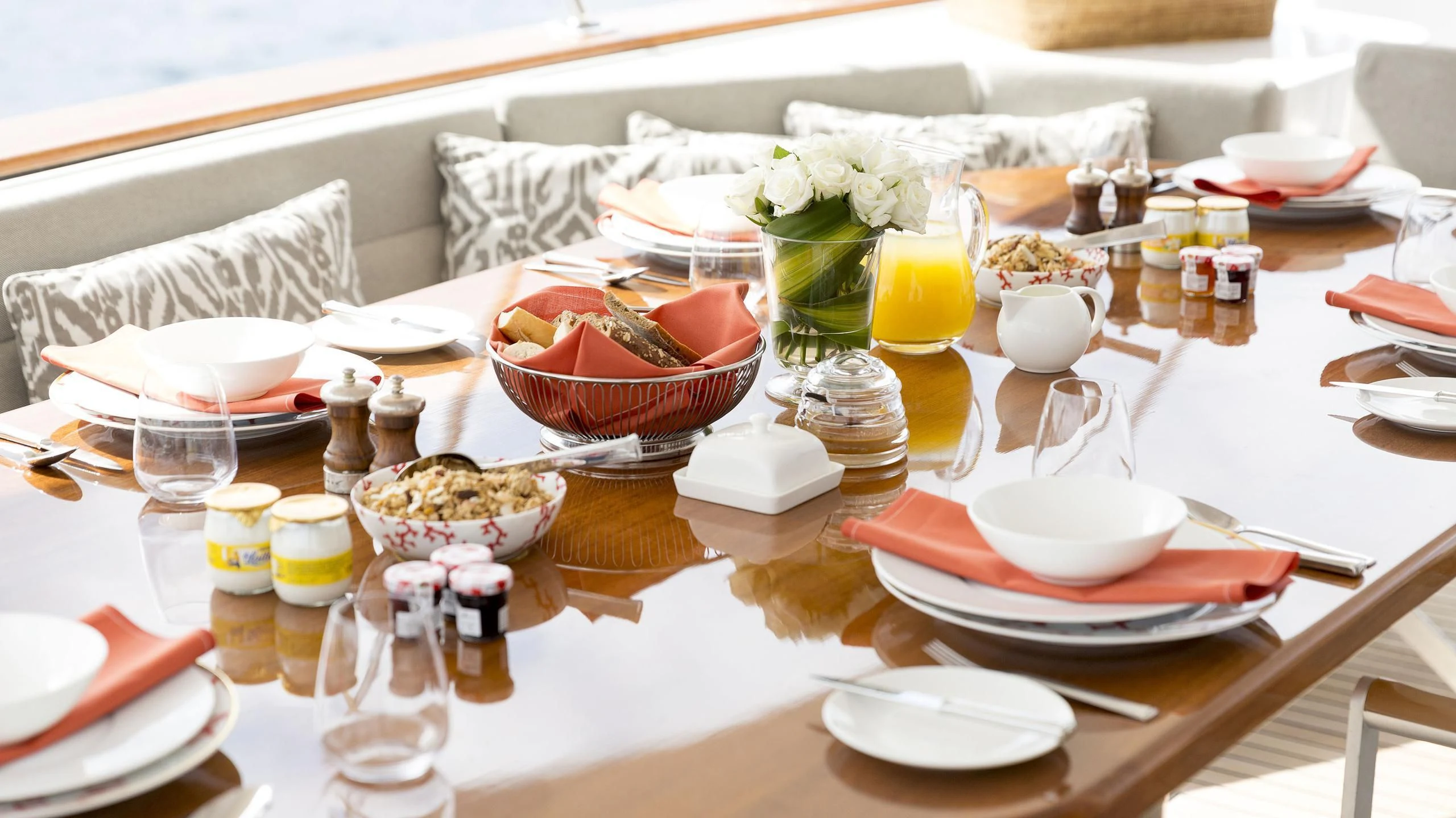 a table with plates and food on it aboard SOLACE Yacht for Sale