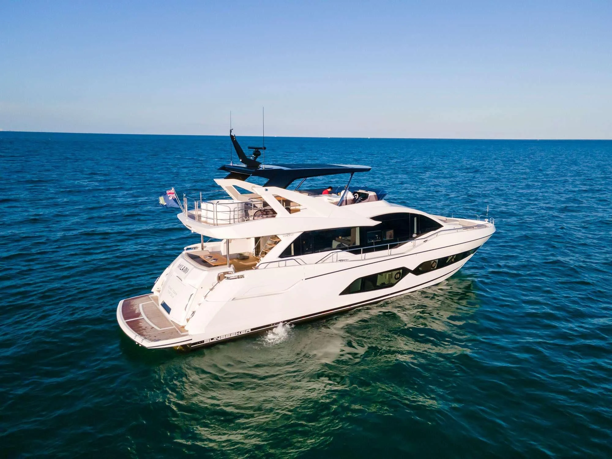 a white yacht in the water aboard MILAMO Yacht for Sale