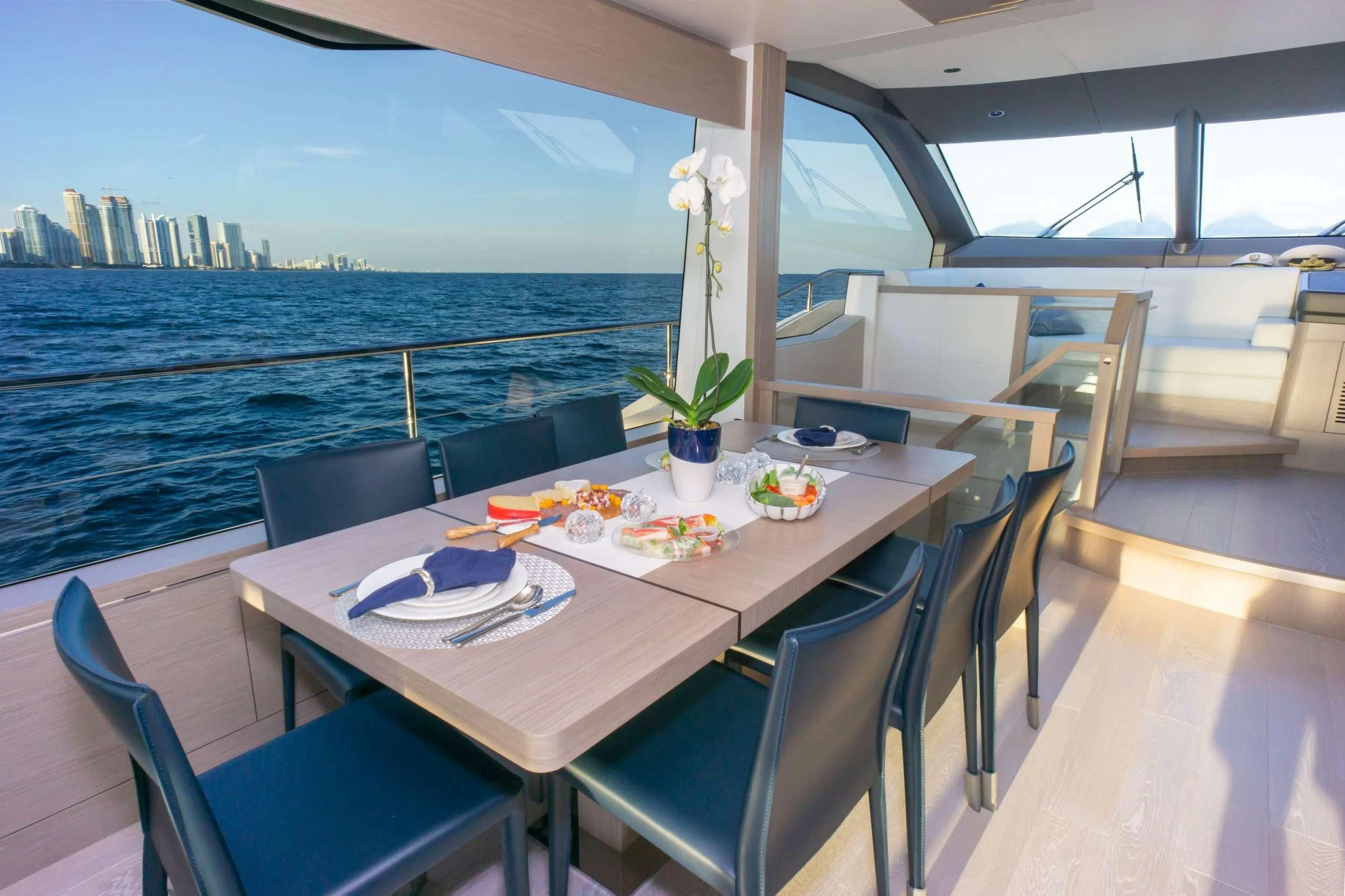 a table with plates and flowers on it aboard MILAMO Yacht for Sale