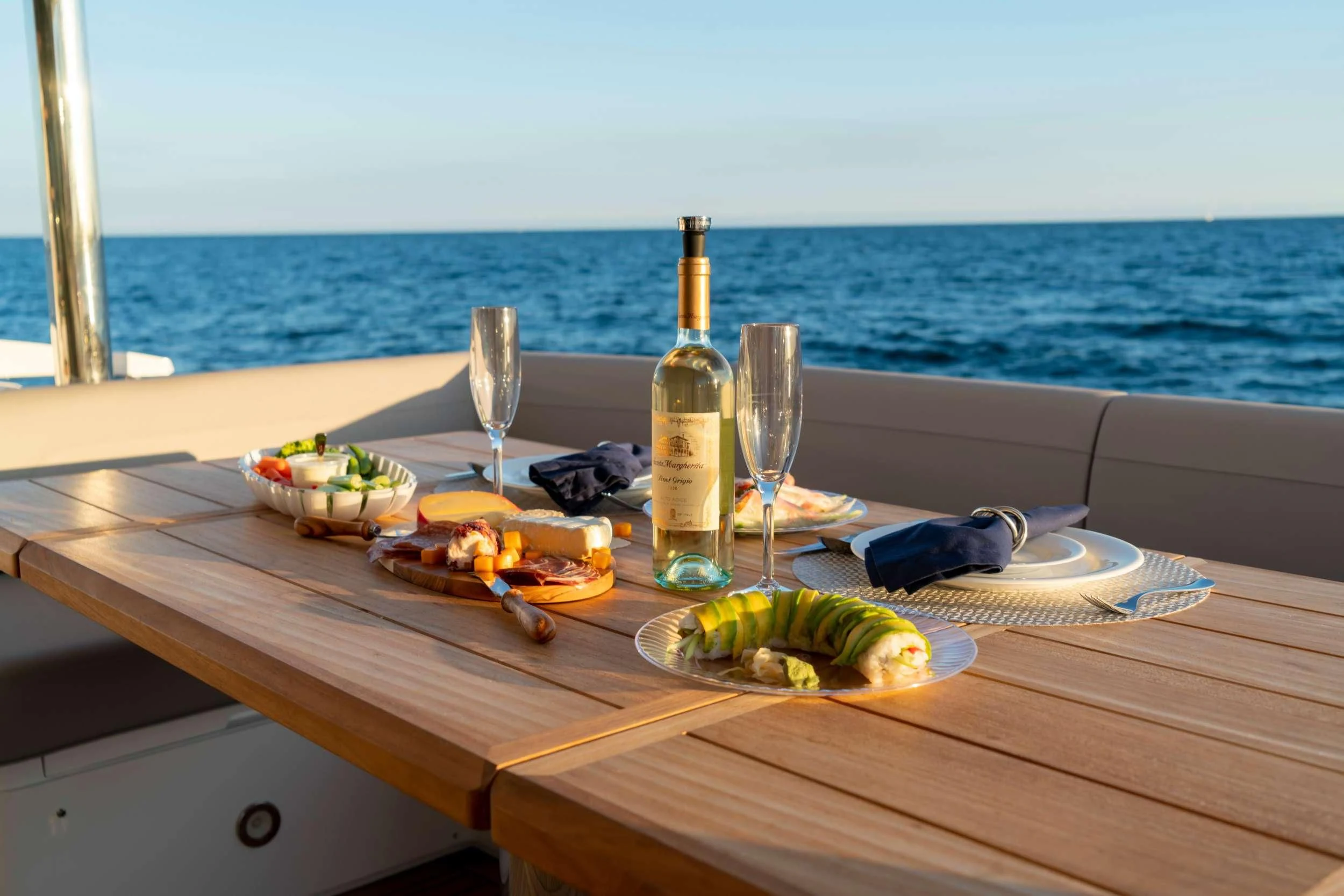 a table with food and wine aboard MILAMO Yacht for Sale