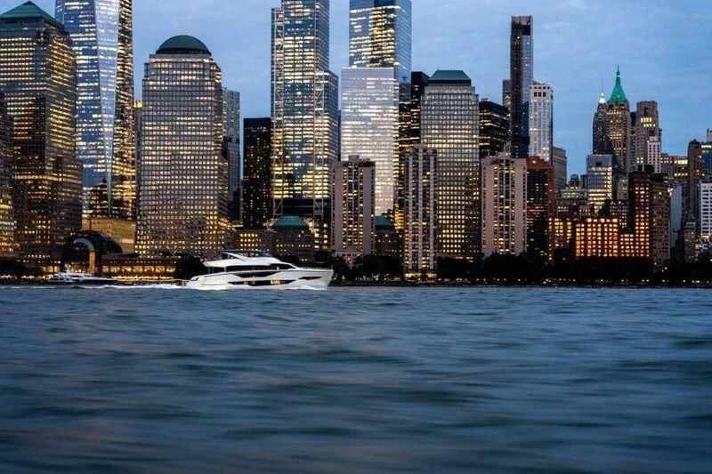 a boat in the water with a city in the background aboard WORTH THE WAIT Yacht for Sale