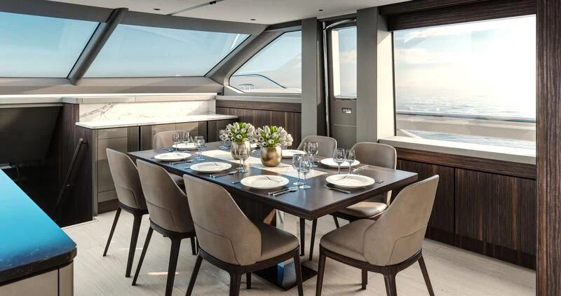 a dining table with chairs and a window aboard WORTH THE WAIT Yacht for Sale