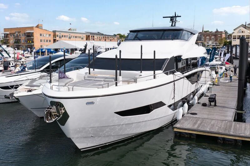 a white yacht docked at a dock aboard WORTH THE WAIT Yacht for Sale